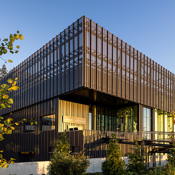Exterior view of the Microsoft Thermal Energy Center, featuring its modern industrial design with sleek metal cladding. Exterior view of the Microsoft Thermal Energy Center, featuring its modern industrial design with sleek metal cladding.