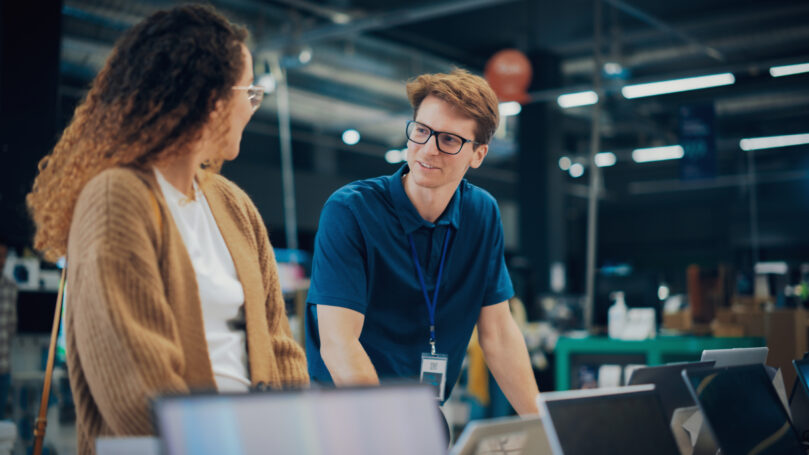A man and woman looking at each other over retail payment innovations