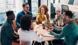 A group of people sitting around a round table