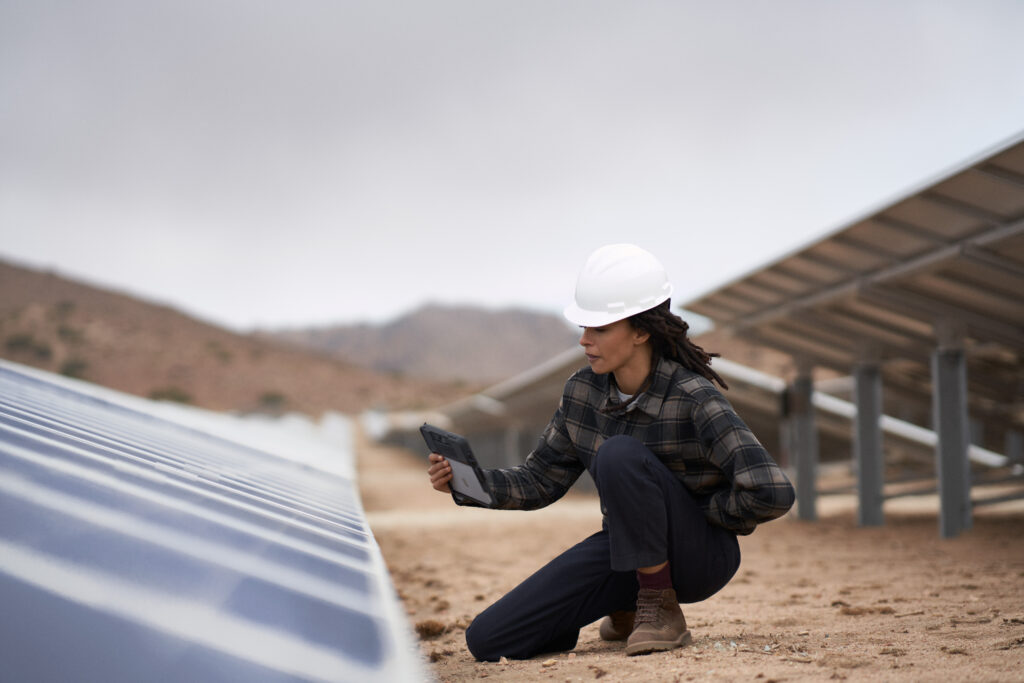 Worker inspecting solar panels