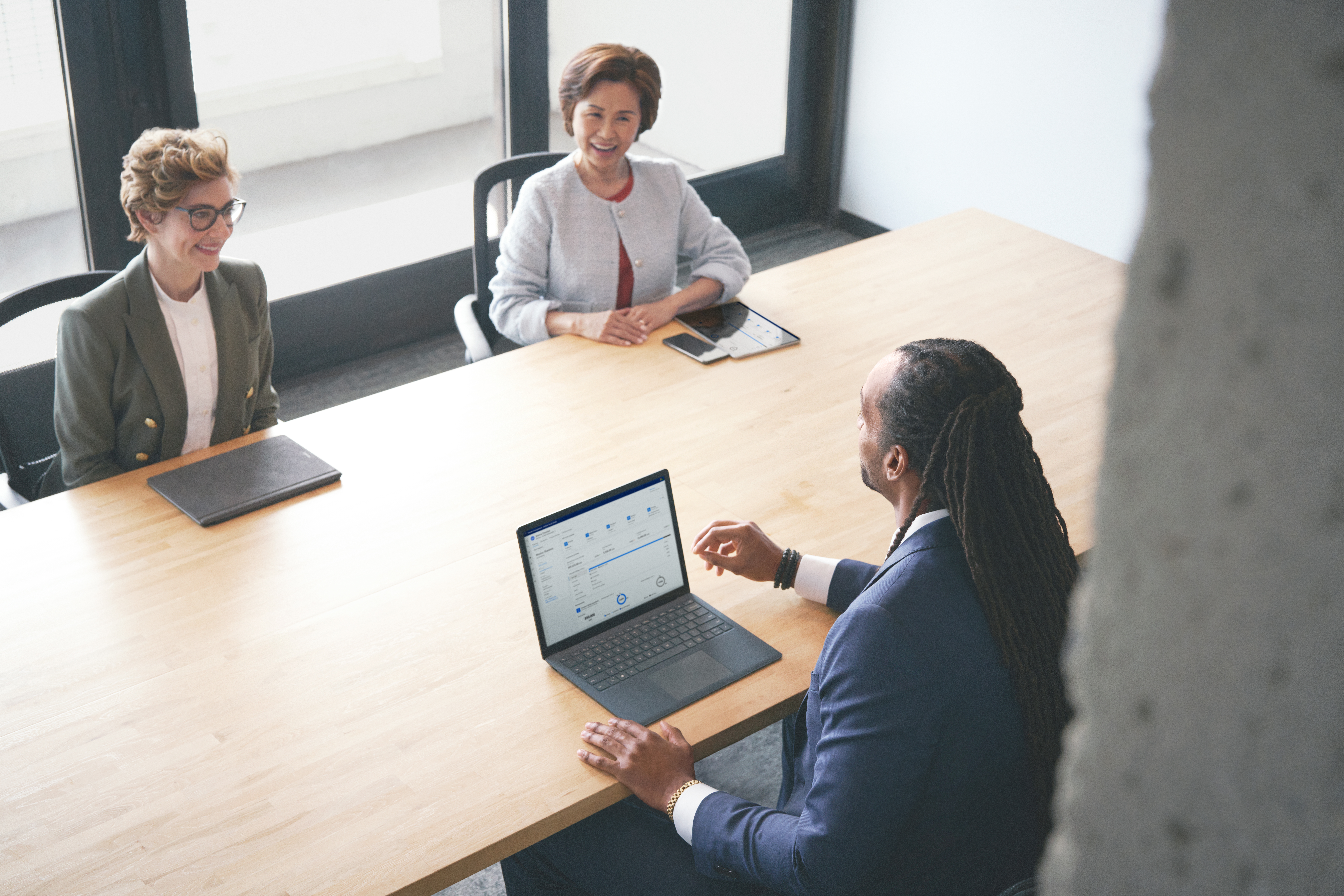 A man sitting at a table with a laptop