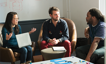 People holding a quick sync-up meeting.