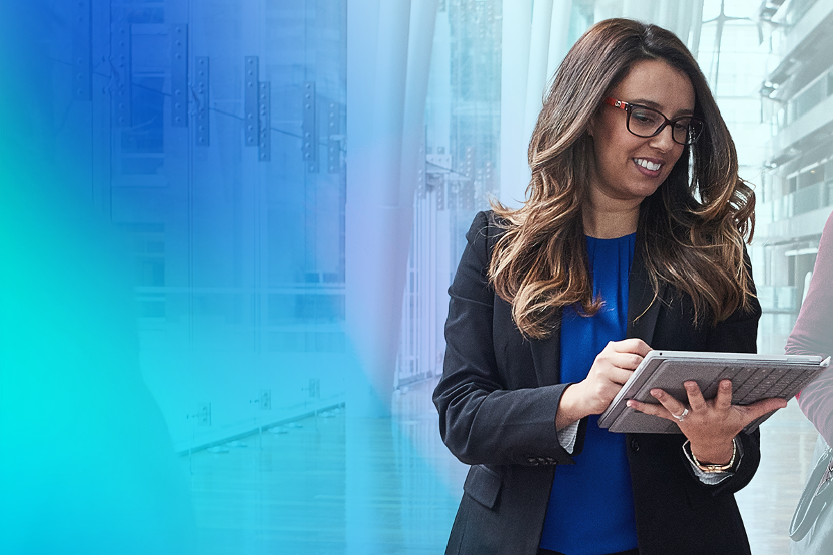 Employee using mobile device with an ombre blue background.