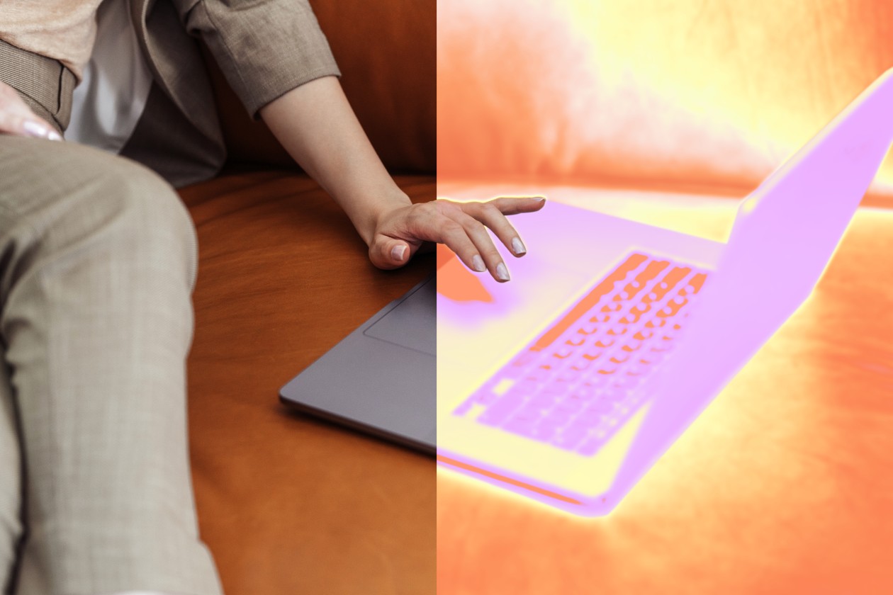 A person sitting on a couch using a laptop