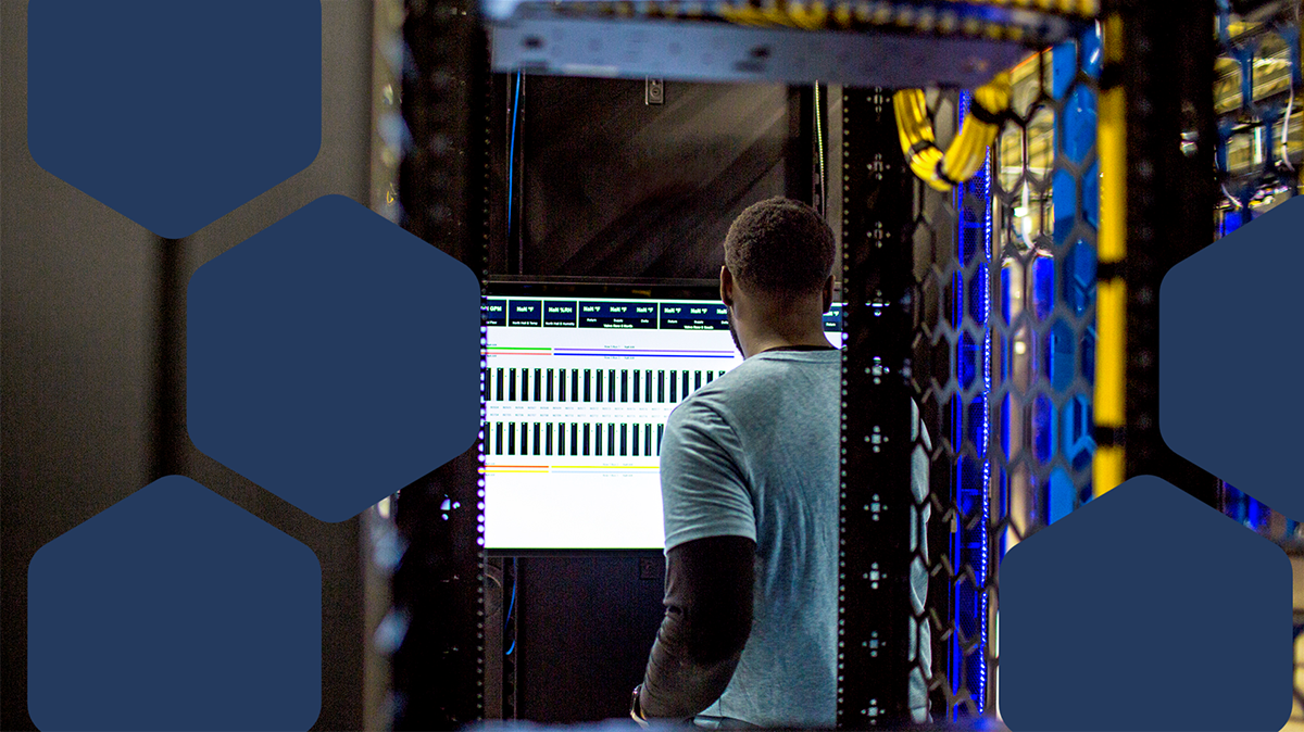 A man standing in front of a computer screen
