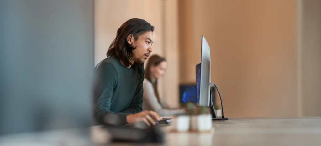 A man sitting at a desk using a computer